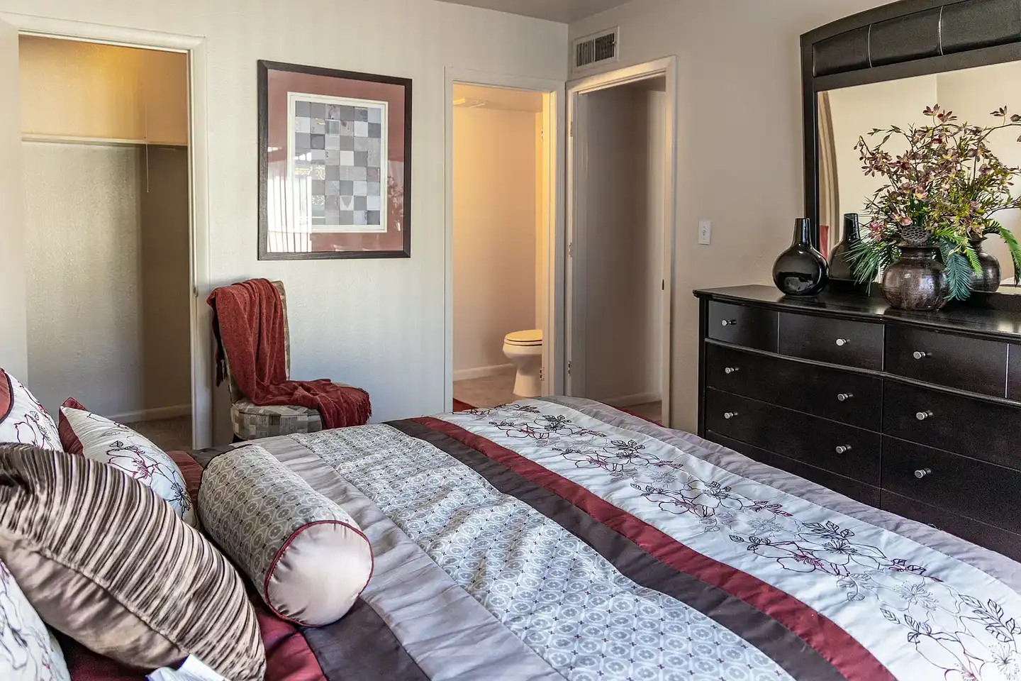 Furnished bedroom shown — representative home at Camelback Courtyard.