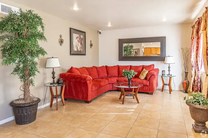 Furnished apartment living area shown — representative home at Camelback Courtyard.