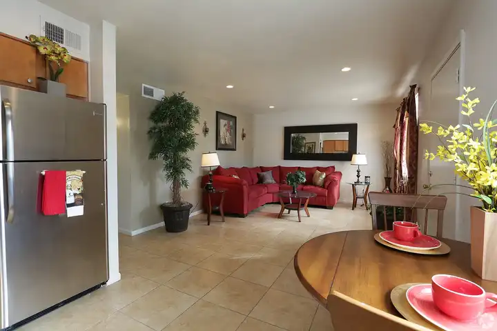 Furnished apartment living area shown — representative home at Camelback Courtyard.