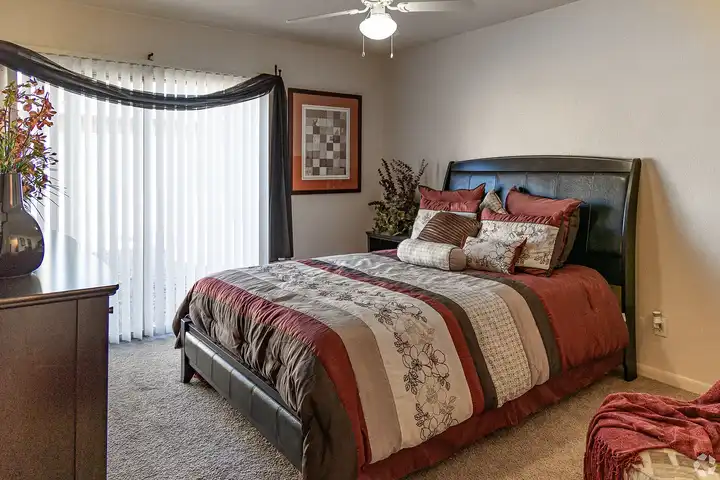 Furnished bedroom shown — representative home at Camelback Courtyard.